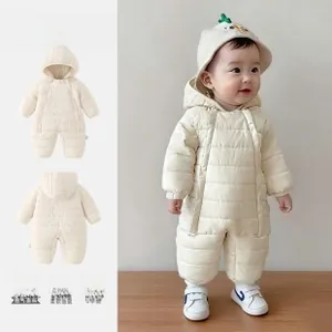 Detail view of cream quilted baby bodysuit with dinosaur hood and warm fleece lining