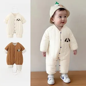 Close-up of quilted baby rompers featuring cartoon dog embroidery and snap button closures