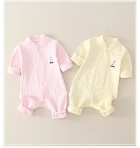 Detailed view of two ribbed cotton newborn rompers with embroidered boat detail