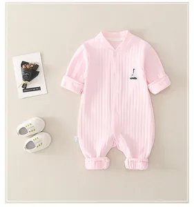 Close-up of pink cotton baby romper featuring ribbed texture and boat embroidery