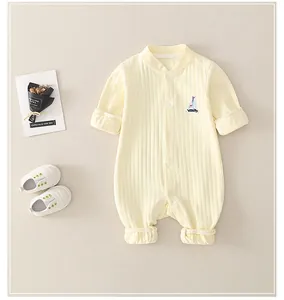 Detail of newborn cotton waffle knit romper with sailboat embroidery and tiny shoes