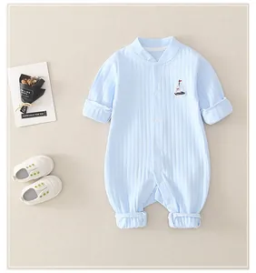 Detail of baby light blue ribbed cotton romper with small sailboat embroidery