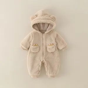 Detail of warm oatmeal baby romper showing teddy ears on hood and soft fleece texture