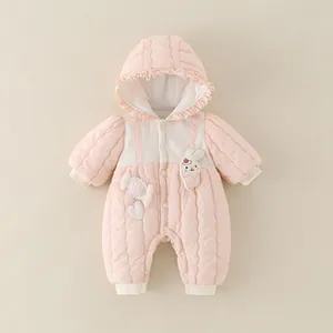 Close-up of pink baby quilted romper with ruffled hood and cute bunny patch detail