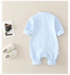 Detail of light blue ribbed cotton baby romper with soft texture and turnover cuffs