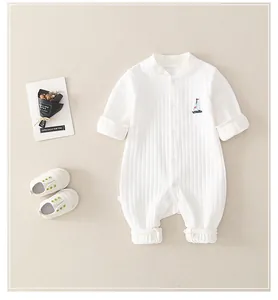 Detail of newborn cotton romper with waffle texture and sailboat embroidery