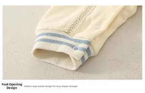 Detail of baby romper ribbed cuffs with hidden snap buttons for easy diaper changes