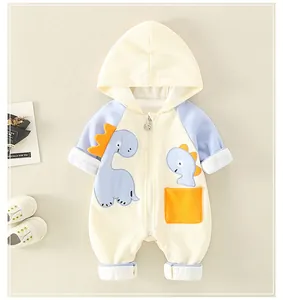 Detail view of cotton baby romper with cartoon dinosaur, orange pocket and zipper closure