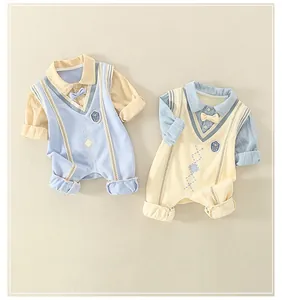 Detail view of two-piece British style cotton baby rompers with embroidery and bows
