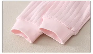 Detail of baby romper with pink ribbed knit fabric and elastic ribbed cuffs for warmth