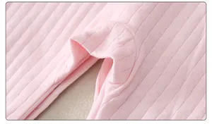 Detailed macro view of pink cotton ribbed knit fabric with delicate diamond cutouts