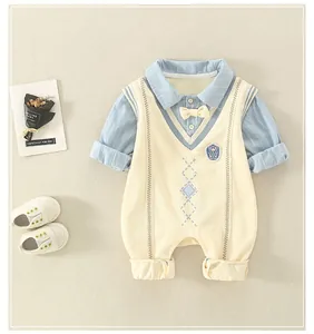 Detailed view of baby romper featuring blue striped collar and white knitted vest design