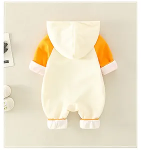 Detail of baby hooded romper with contrast orange sleeves and white folded cuffs