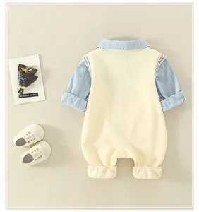 Flat lay of baby girl cotton romper set with light blue stripes and cream vest