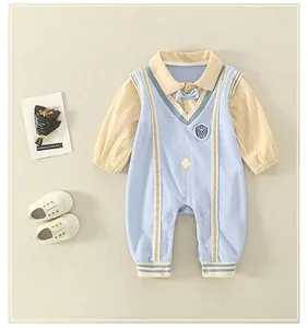Detailed view of baby romper featuring a blue knit vest, striped sleeves, and bow tie