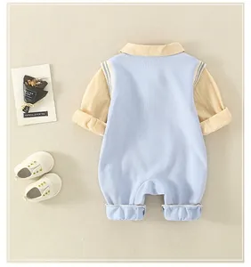 Detail of baby cotton romper featuring traditional frog buttons and striped sleeves