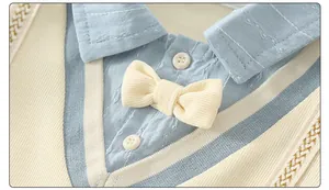 Close-up of baby romper with Chinese-style collar, knit vest, and bow tie detail