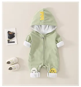 Detail von hellgrünem Baby-Kapuzen-Strampler mit gelben Dinosaurier-Zacken und Reißverschluss