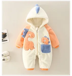 Close-up of baby dinosaur romper with plush fleece texture and embroidery detail