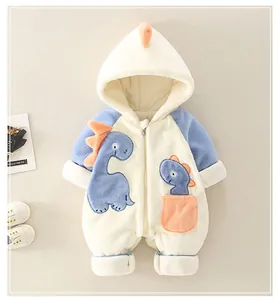Detail of dinosaur baby romper with fleece lining and orange pocket accents