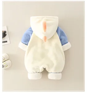 Detail of baby winter romper featuring a dinosaur fin hood and soft fleece texture