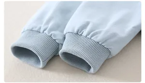 Close-up of baby romper ribbed cuffs made from soft cotton with detailed knit texture