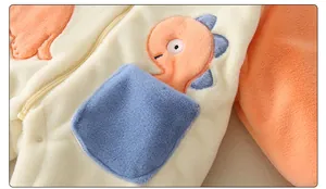 Detail of baby warm romper with dinosaur embroidery and soft fleece fabric texture