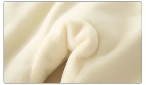Close-up of soft cream white fleece lining showing plush texture of baby winter romper