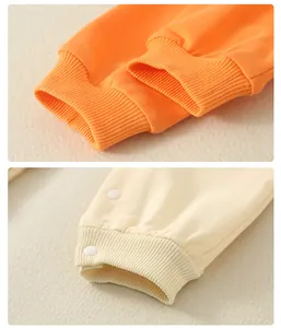 Detailed view of elastic ribbed cuffs and snap button on soft cotton newborn bodysuit