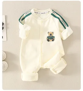 Close-up of baby romper featuring a cute cartoon bear print and snap-button closure