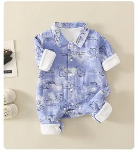 Detailed view of light blue corduroy baby romper featuring printed teddy bears and white collar