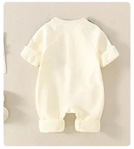 Detail of baby cotton romper back view with raglan sleeves and folded cuffs in cream