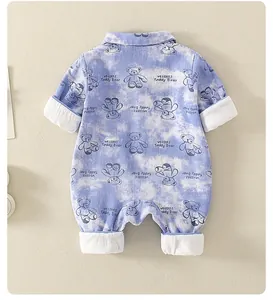 Detail of baby cotton romper with blue tie-dye clouds and cute teddy bear prints