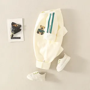 Creamy white baby cotton sweatpants featuring cute bear print and green side stripes