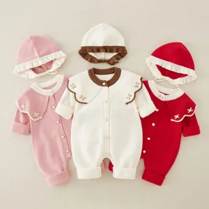 Baby knitted romper with ruffle hat showing collar embroidery and pearl buttons