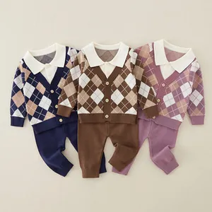 Detail of infant knit two-piece set featuring diamond pattern and white polo collars