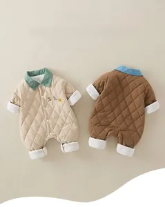 Detail of baby quilted rompers featuring smiley embroidery and soft ribbed cuffs