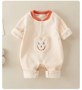 Detail of baby romper featuring warm fleece texture, smile pocket and snap buttons