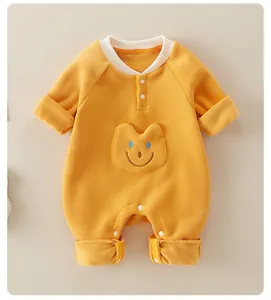Close-up of thick mustard yellow baby fleece romper with cute animal face embroidery