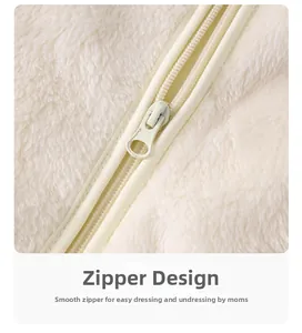 Detail of smooth resin zipper on soft cream fleece newborn jumpsuit for easy dressing