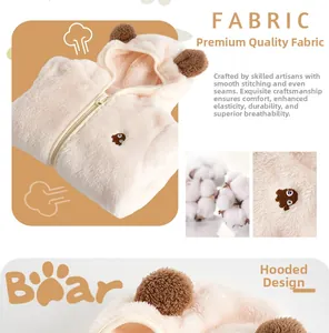 Detailed view of plush coral fleece fabric and cute bear embroidery on baby romper