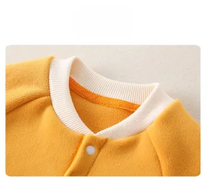 Close-up of baby fleece romper featuring ribbed collar and white snap button closure