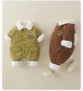 Detail of baby corduroy romper featuring cartoon bear embroidery and fleece collar