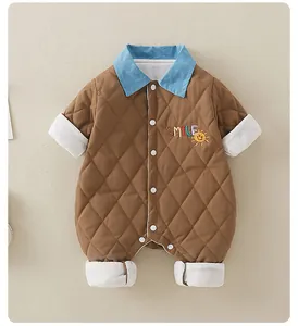 Close-up of quilted baby romper with smile embroidery and contrast blue collar detail