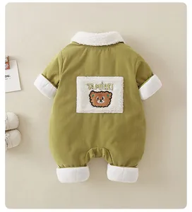 Detail of olive green corduroy baby romper with plush bear patch and fleece collar