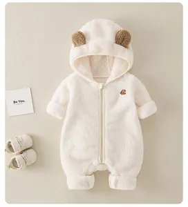 Detailed flat lay of a white fleece baby romper with bear ears and soft zipper closure