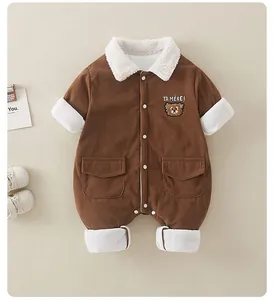 Close-up of brown corduroy baby romper with fleece trim and cute bear embroidery