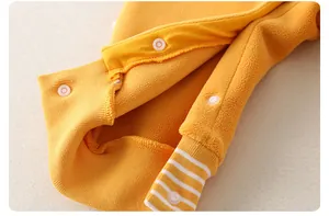 Detail of soft fleece lining with snap buttons and striped ribbed cuffs for baby romper