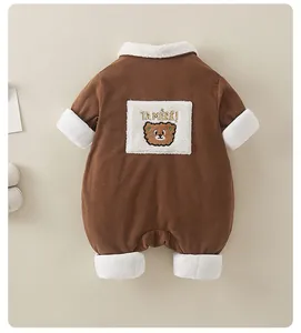 Detail of corduroy baby romper showing soft fleece teddy bear patch and thick warm lining