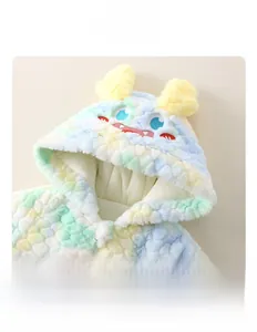 Detail of baby hooded romper with colorful plush fabric and cute monster ear design
